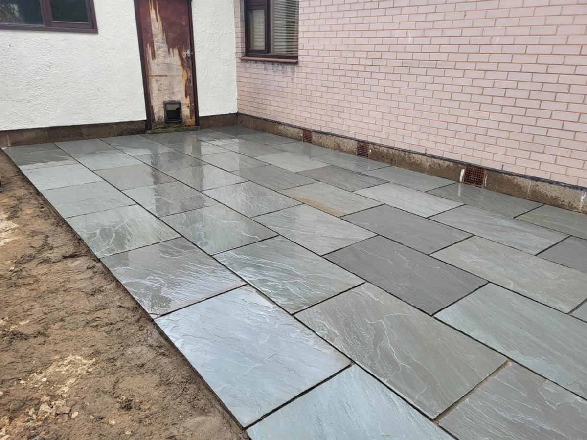 Light grey sandstone patio, freshly laid and still wet